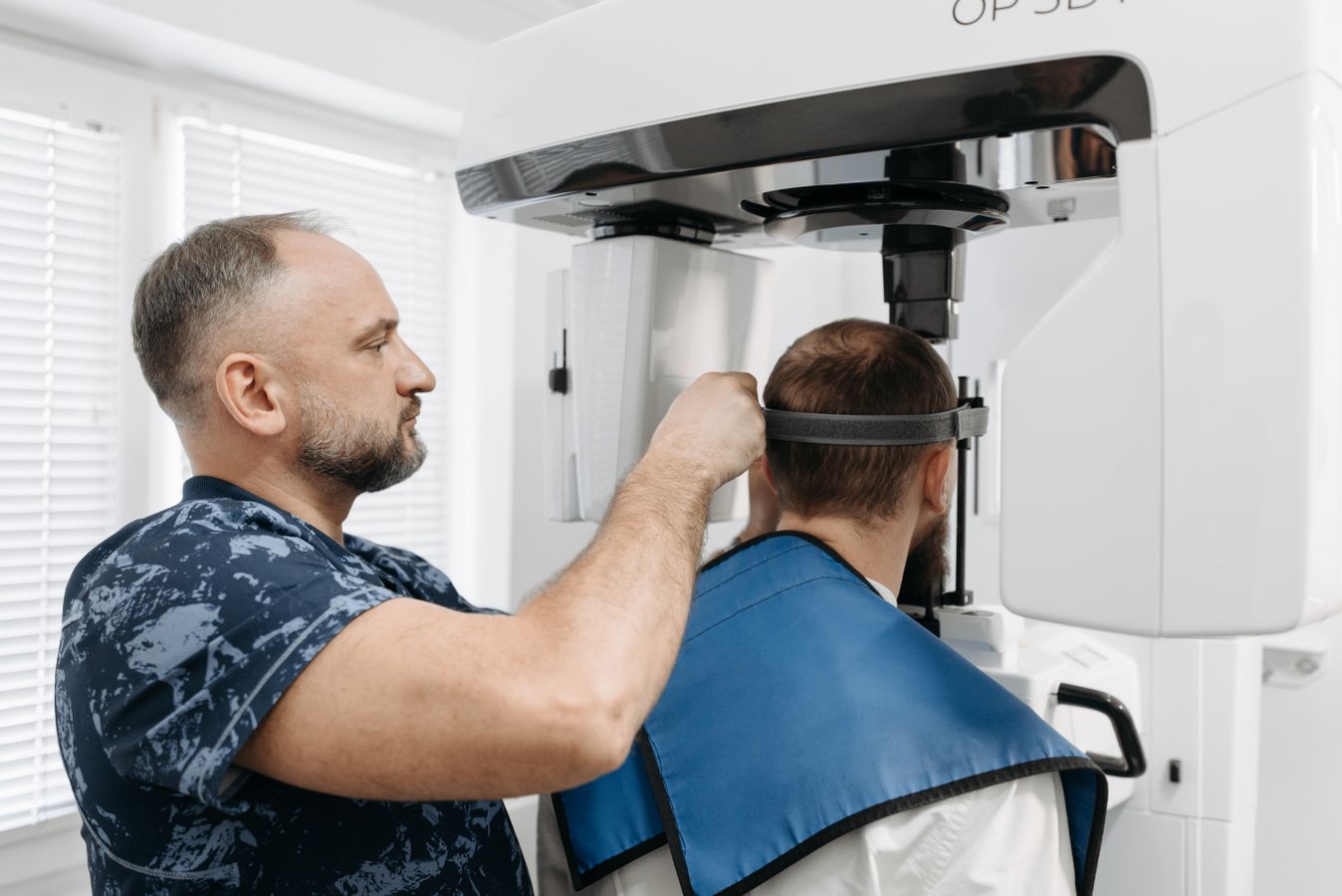 A patient being positioned for advanced three-dimensional dental imaging