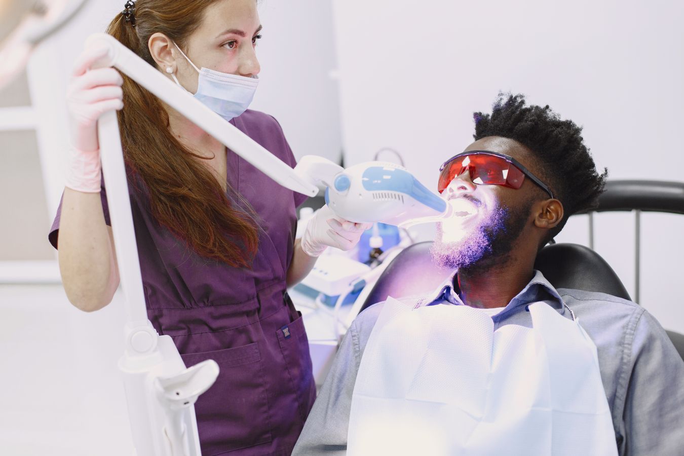 A patient receiving professional teeth whitening in a dental clinic